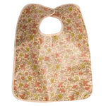 A clip-on bib by Bonpoint in yellow Liberty fabric, featuring a charming floral pattern and a practical plastic-coated finish.