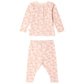 The Baby Girls’ and Girls’ Genna Set by Bonpoint features a pink long-sleeve top and matching pants with an all-over light pink and peach abstract dot pattern, crafted from soft organic cotton, displayed front and back on a white background.