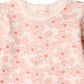 Bonpoint Baby Girls’ and Girls’ Genna Set features a cream-colored knit top adorned with a pink floral pattern and a delicate lace-trimmed collar—an ideal choice for a refined, lace-accented baby outfit. Only the upper front portion of the garment is shown.