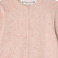 A close-up of a pale pink knit baby cardigan with a delicate cherry pattern, round neckline, and small front buttons. The brand label “Bonpoint” is visible inside the collar, making it a charming layering piece to pair with Baby Girls’ Golco Pajamas with Cherry Pattern for extra warmth.