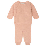 The Baby Girls’ Ging Fancy-Stitch Set in Cashmere by Bonpoint features a pink ribbed knit wrap-style top with side buttons and matching pants, both beautifully displayed flat on a white background. This decorative cashmere set brings unparalleled softness and charm to any little one’s wardrobe.