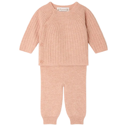 The Baby Girls’ Ging Fancy-Stitch Set in Cashmere by Bonpoint features a pink ribbed knit wrap-style top with side buttons and matching pants, both beautifully displayed flat on a white background. This decorative cashmere set brings unparalleled softness and charm to any little one’s wardrobe.