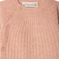 Close-up of the Baby Girls’ Ging Fancy-Stitch Set in Cashmere, a pink ribbed knit sweater with decorative stitch details and three buttons on the shoulder, featuring a Bonpoint label sewn inside the neckline.