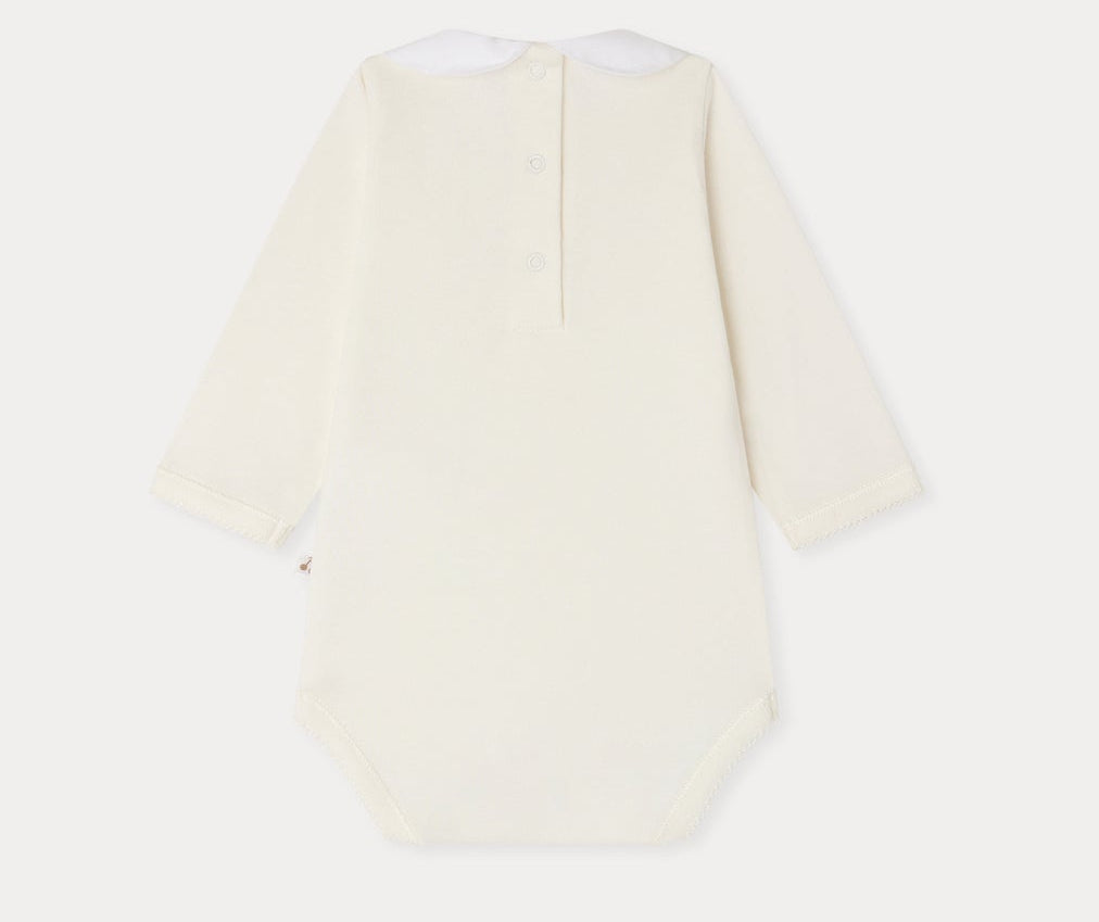 The Bonpoint Baby Cygne Bodysuit is a long-sleeve cream onesie made from soft organic cotton, featuring a white collar and button closure at the back, shown laid flat against a white background.