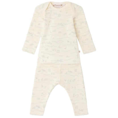 The Bonpoint Baby Timi Set with Sheep Print features a long-sleeve cream organic cotton top and matching pants adorned with a light grey animal and landscape motif. This comfortable baby outfit highlights an adorable sheep detail and is presented against a plain white background.