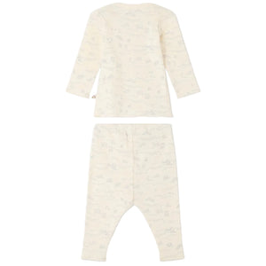 The Bonpoint Baby Timi Set with Sheep Print is a cream-colored long-sleeve shirt and pants ensemble crafted from organic cotton, adorned with a delicate animal and landscape pattern featuring charming sheep. This comfortable baby outfit is displayed from the back against a white background.