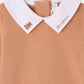 Close-up of Bonpoint’s Baby Boys’ Septembre Bodysuit in tan organic cotton, featuring a crisp white collar delicately hand-embroidered with “Bonjour” and a small gold teddy bear, capturing the timeless charm of the brand.