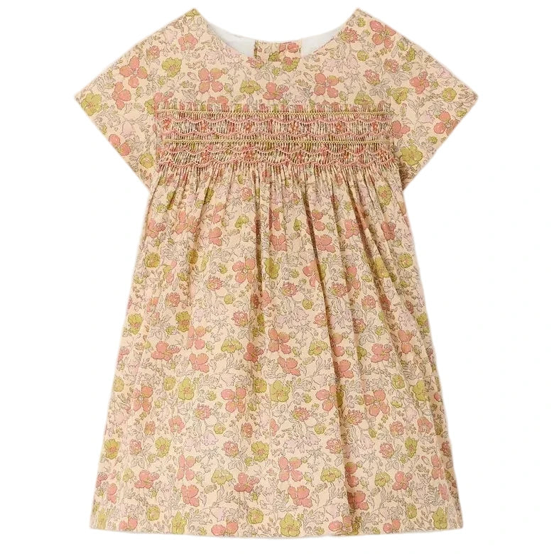 Bonpoint’s Baby Girls’ and Girls’ Maruska Dress features short sleeves, smocked and hand-embroidered detailing across the chest, a floral Liberty Tana Lawn fabric, and an A-line silhouette, shown against a plain background.