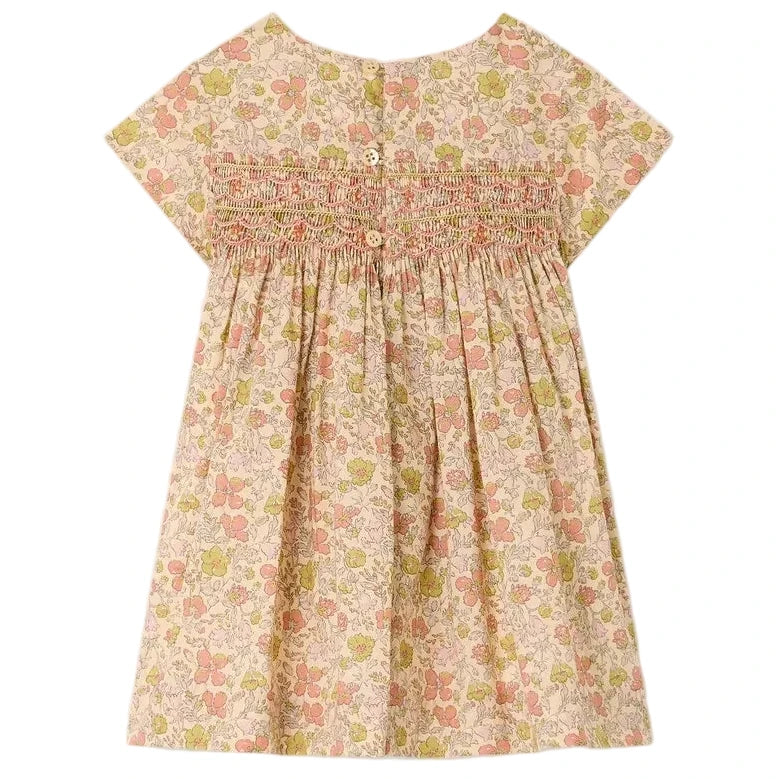 Bonpoint’s Baby Girls’ and Girls’ Maruska Dress in Liberty fabric is a short-sleeve style, smocked and hand-embroidered, featuring a charming floral pattern with pink and green flowers. Made from Liberty Tana Lawn, it includes two back buttons for easy dressing.