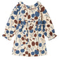 The Baby Girls’ Melyssa Dress with Cherry Print by Bonpoint features long sleeves, a ruffled collar, and a gathered waist; crafted from organic cotton corduroy and displayed on a white background.