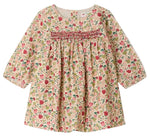 The Bonpoint Baby Girls’ and Girls’ Félicie Dress features long sleeves, a charming pink, green, and beige floral pattern, hand-embroidered smocking across the chest, and a loose, comfortable fit.