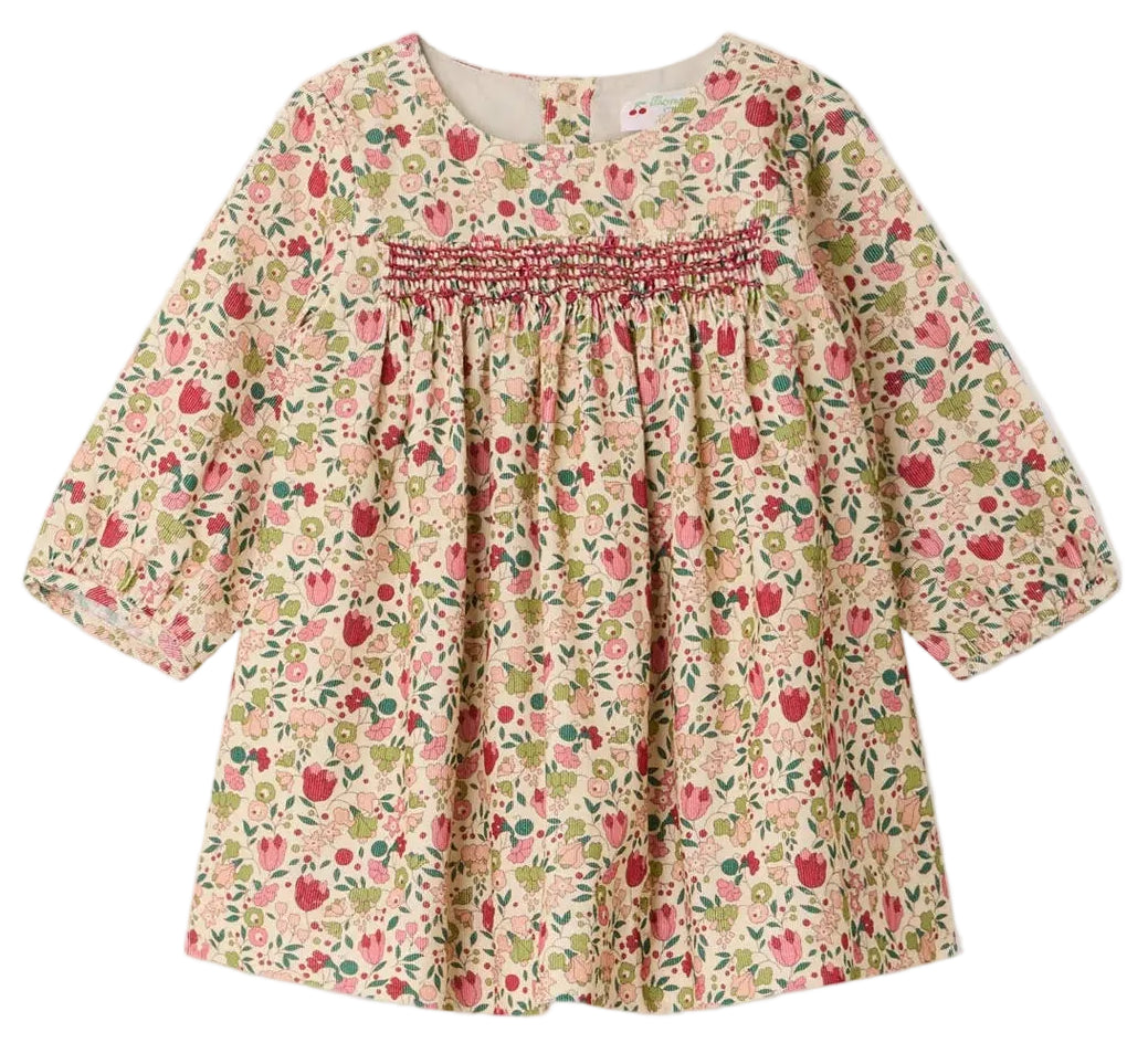The Bonpoint Baby Girls’ and Girls’ Félicie Dress features long sleeves, a charming pink, green, and beige floral pattern, hand-embroidered smocking across the chest, and a loose, comfortable fit.
