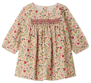 The Bonpoint Baby Girls’ and Girls’ Félicie Dress features long sleeves, a charming pink, green, and beige floral pattern, hand-embroidered smocking across the chest, and a loose, comfortable fit.