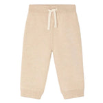 The Bonpoint Baby Girls’ and Girls’ Bambo Beige Jogging Bottoms, crafted from soft organic cotton fleece, feature ribbed cuffs, an elastic waistband with a drawstring, and a delicate embroidered cherry detail—shown on a white background.