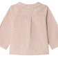 Back view of the Bonpoint Baby Boys’ and Boys’ Boubou Shirt, a long-sleeve shirt in light pink and white stripes, made from soft organic cotton with a collar, yoke detail, and buttoned cuffs.