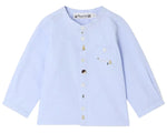 The Bonpoint Baby Boys’ and Boys’ Matis Shirt features a light blue, long-sleeve design with white buttons and a left chest pocket, adorned with charming hand-embroidered fir trees, hedgehogs, and bees.