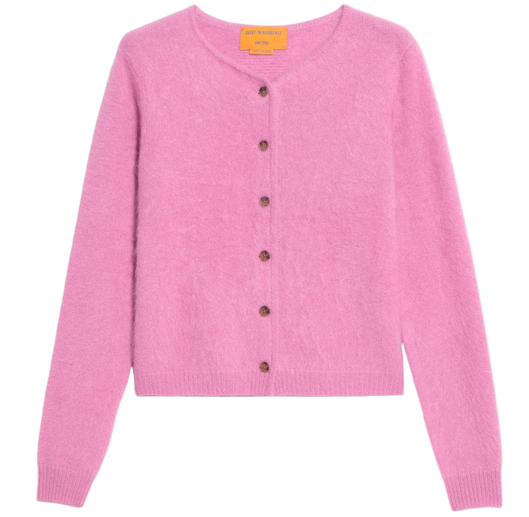 The Grizzly Cashmere Cardigan by Guest in Residence is a pink, brushed-effect women’s knitwear piece with long sleeves, a crew neck, and brown buttons, shown on a white background.