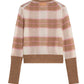 The Shadow Plaid Cardigan by Guest in Residence is a lightweight knit with long sleeves, featuring a brown, beige, and pink plaid pattern and solid brown ribbed cuffs and waistband.