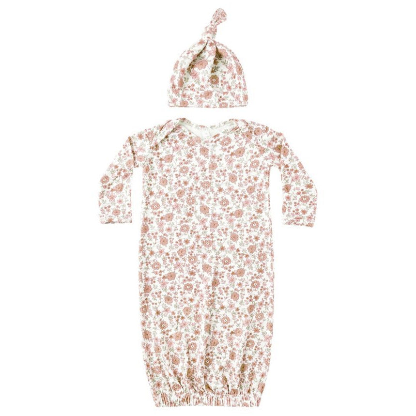 The Quincy Mae Baby Girls' Bamboo Baby Gown & Hat Set includes a long-sleeve gown with fold-over mitts, elastic bottom, and a matching knotted hat, both featuring a pink and white floral pattern.