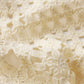Close-up of The Postcard Cardi by Frame, featuring off-white crocheted fabric with a lacy, open pattern and textured yarn—highlighting the delicate details perfect for a lightweight cardigan.