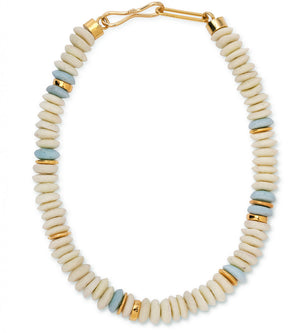 The Laguna Necklace by Lizzie Fortunato features off-white disc-shaped recycled glass beads, accented with gold and light blue beads, and finished with a gold hook clasp.