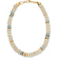 The Laguna Necklace by Lizzie Fortunato features round white and pale blue recycled glass beads with gold spacers, finished with a gold hook clasp.