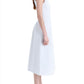 A woman with long hair wearing the Proenza Schouler Shelby Dress, a sleeveless white cotton linen piece featuring a fit and flare silhouette, stands in side profile against a white background.