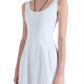 Woman wearing a sleeveless, scoop-neck white Proenza Schouler Shelby Dress made of Cotton Linen, standing against a white background with her head cropped out of the frame.