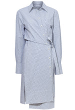 A long-sleeve, blue and white grid print dress with a collared neckline and a button-down front. The Proenza Schouler Lane Wrap Dress by Proenza Schouler features a waist tie and a side slit.