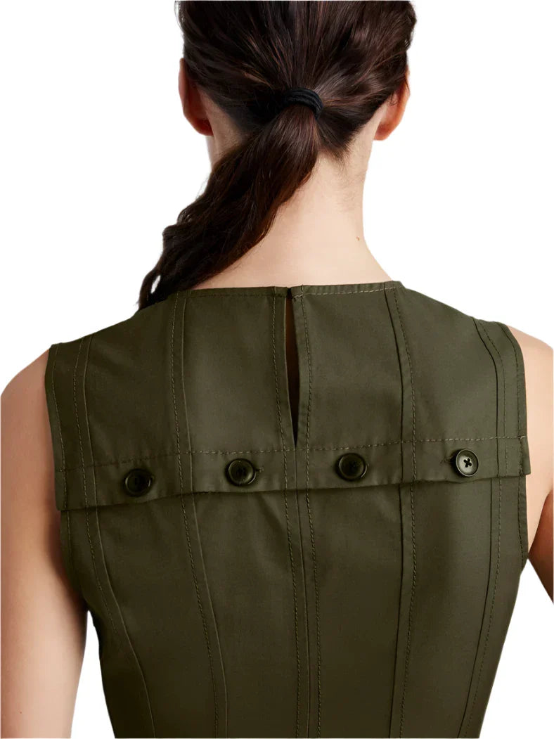 A person with dark hair in a ponytail is shown from the back, wearing a sleeveless olive green top that features vertical stitching and a buttoned detail near the shoulder area, similar to the Proenza Schouler Marley Dress.