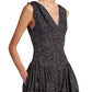 A person wearing a sleeveless Clayton Dress Printed Poplin by Proenza Schouler White Label, featuring a black design with small white dots and a V-neckline, perfecting an elegant yet timeless style.