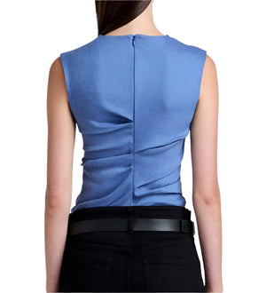 View of a person wearing the Proenza Schouler White Label Anoushka Top Linen Slub in blue and black pants, highlighting a fitted sleeveless design with fluid ruching and a back zipper.