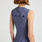A person with short brown hair is seen from the back wearing the Marley Brushed Poplin Dress by Proenza Schouler White Label, a sleeveless, fitted blue dress with black buttons along the upper back and a subtle A-line shape.