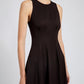 A woman models the Proenza Schouler White Label Bronwyn Merino Wool Twill Dress, a sleeveless, fitted style with a round neckline, shown from shoulders to mid-thigh against a plain background.