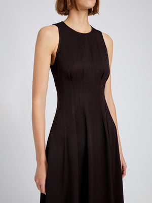 A woman models the Proenza Schouler White Label Bronwyn Merino Wool Twill Dress, a sleeveless, fitted style with a round neckline, shown from shoulders to mid-thigh against a plain background.