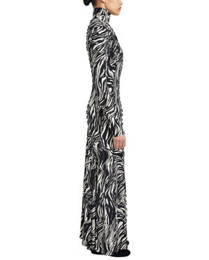 A person in profile wears the Mabel Marble Jersey Dress by Proenza Schouler White Label—a long-sleeve turtleneck maxi featuring a bold black and white marble print.