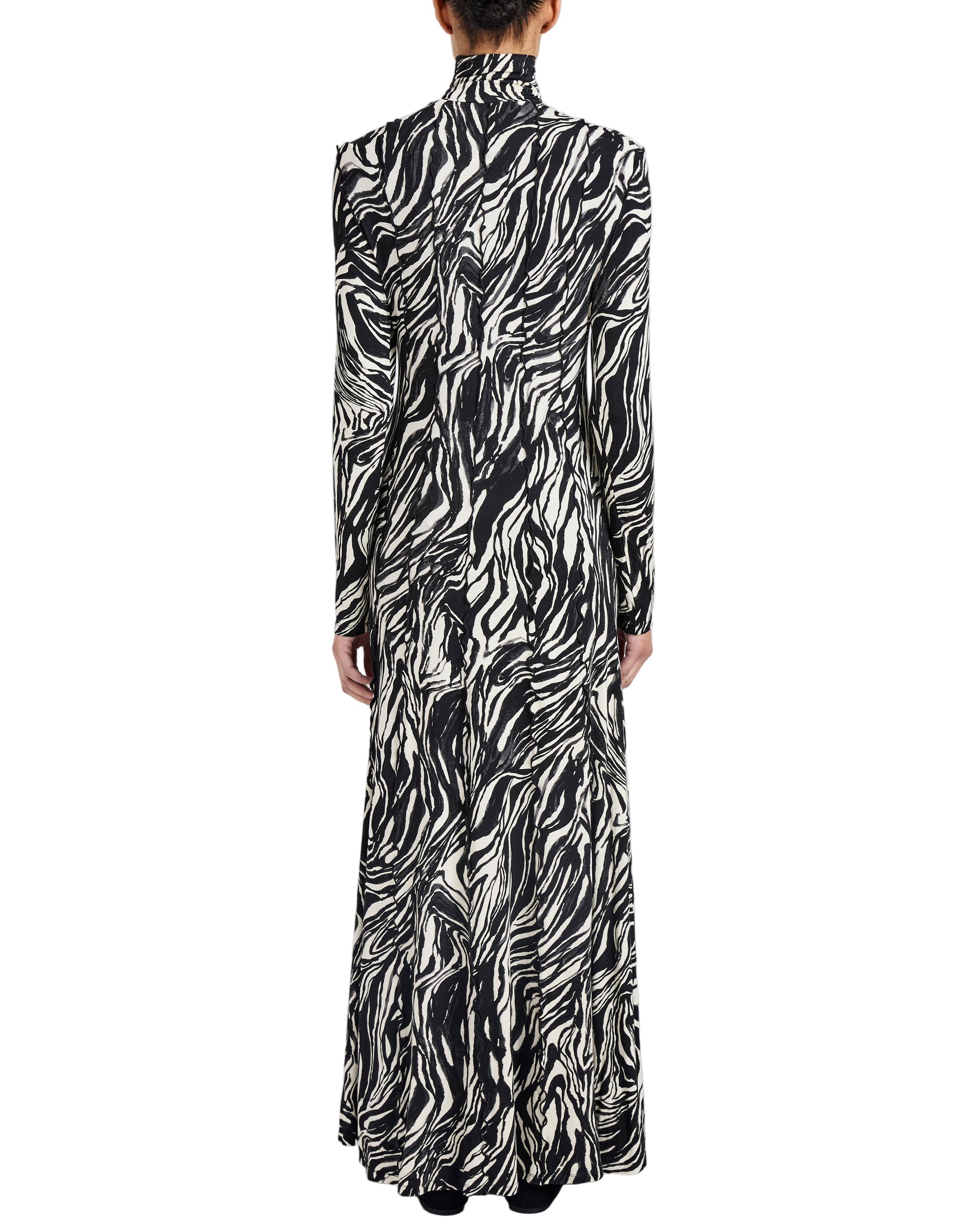 A person is shown from the back against a white background wearing the Proenza Schouler White Label Mabel Marble Jersey Dress, featuring long sleeves, a turtleneck, and a black-and-white marble print.