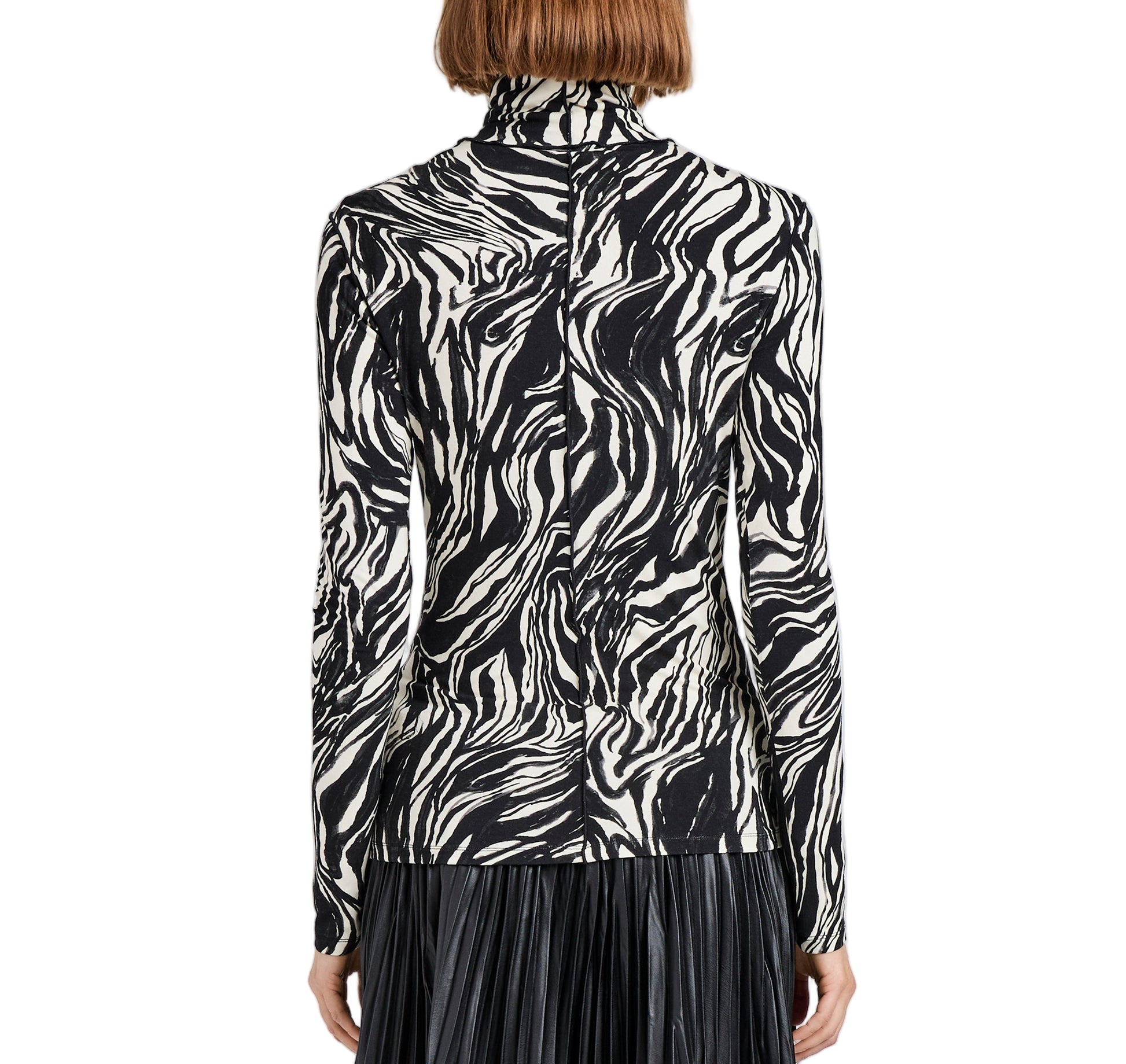 A person shown from the back wears the Audrey Marble Jersey Top by Proenza Schouler White Label—a slim, long-sleeve turtleneck with a black and white print—paired with a black pleated skirt.