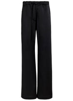 The Proenza Schouler White Label Magnus Crinkled Crepe Pant features a black high-waisted, wide-leg silhouette with an elastic waistband and drawstring tie, shown against a plain white background.