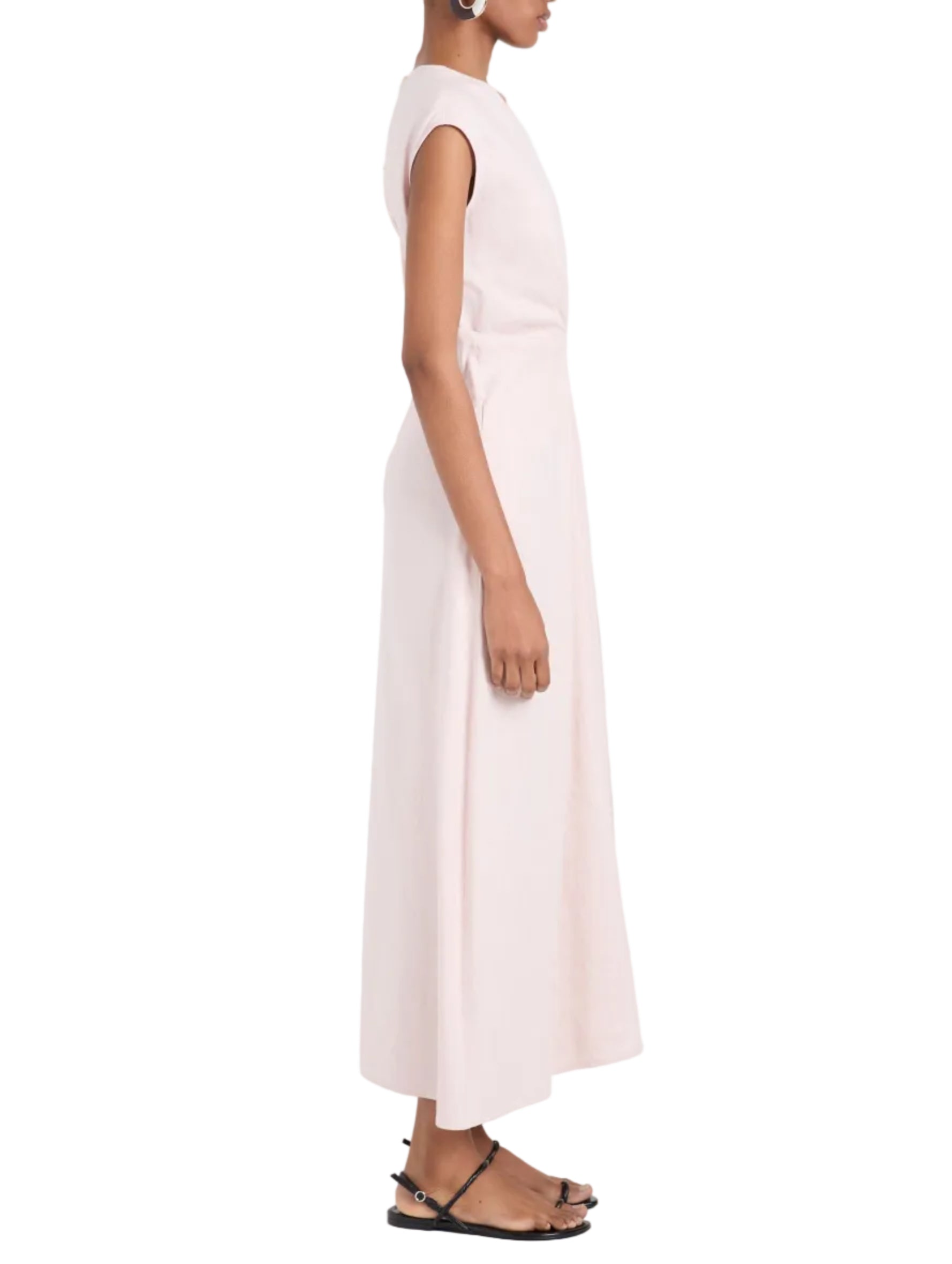 A person wearing the Proenza Schouler White Label Miranda Dress, a sleeveless A-line style, pairs it with black sandals and stands in profile against a white background.