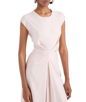 A woman wears the Miranda Dress by Proenza Schouler White Label—a light pink, short-sleeve Linen Slub dress with an A-line silhouette and gathered waist—standing against a plain white background.