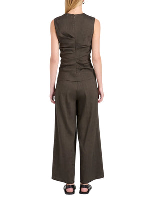 A person is seen from the back against a white background, wearing the Proenza Schouler White Label Anoushka Slub Linen Top in dark brown, styled with matching wide-leg pants for a sleeveless look.