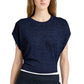 A woman models the Reeva Marled Jersey Top by Proenza Schouler White Label—navy blue, short-sleeve, loose-fit with a crew neckline—paired with black pants, shown from shoulders to waist against a plain background.
