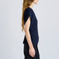 A person with long hair wears the Reeva Marled Jersey Top by Proenza Schouler White Label and black pants, shown in side profile against a plain light background.