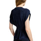 A person with light skin and brown hair is seen from the back wearing the Proenza Schouler White Label Reeva Marled Jersey Top, a navy blue sleeveless cropped tee with a cinched waist detail.