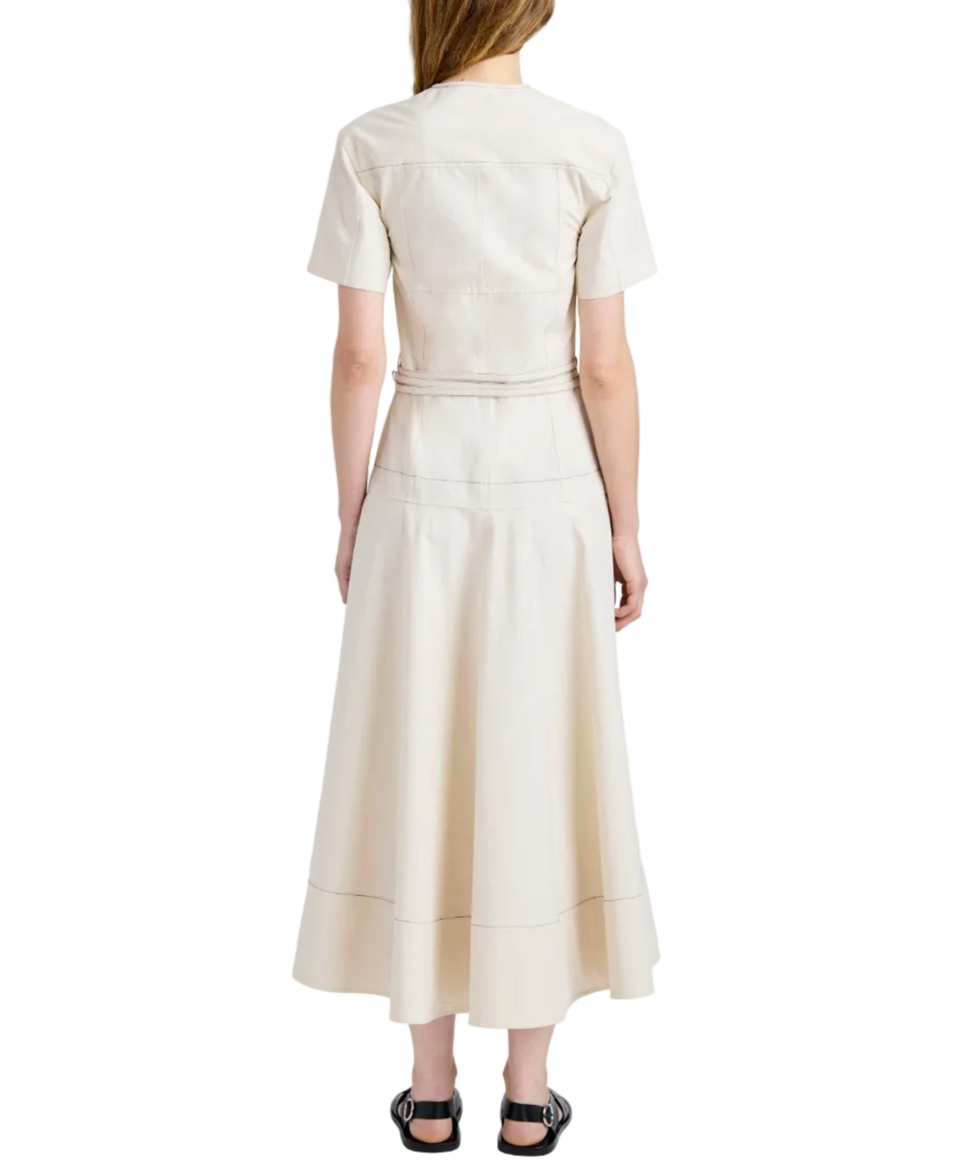 A woman faces away, wearing a Proenza Schouler White Label Elizabeth Dress in cotton linen with short sleeves and black sandals, set against a white background.