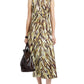 A woman wears the Anoushka Dress by Proenza Schouler White Label—a sleeveless midi poplin dress with a brown, yellow, and white abstract brushstroke print—paired with a dark brown bag and black sandals.