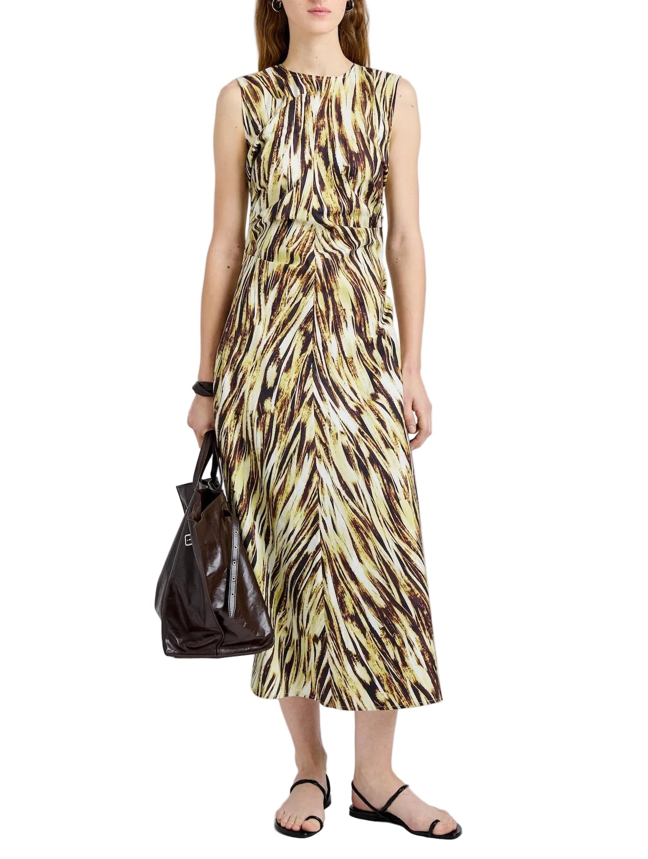 A woman wears the Anoushka Dress by Proenza Schouler White Label—a sleeveless midi poplin dress with a brown, yellow, and white abstract brushstroke print—paired with a dark brown bag and black sandals.