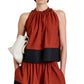 Cropped silhouette of a person wearing the Esme Top by Proenza Schouler White Label, holding a white clutch bag, shown from shoulders to knees against a plain background.