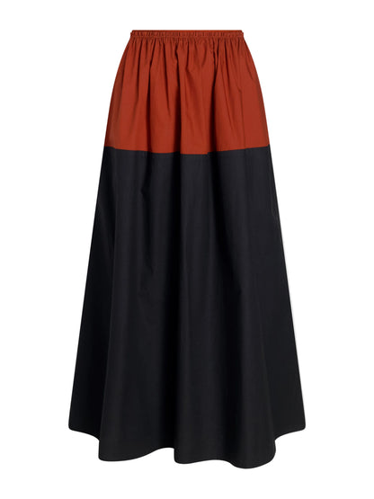 The Nyla Skirt by Proenza Schouler White Label is an A-line poplin skirt with color-blocking, featuring a rust-colored top, black lower section, and an elastic waistband.